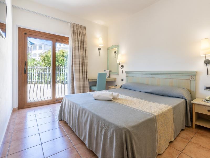 Un letto posizionato in una camera da letto accanto a un balcone.